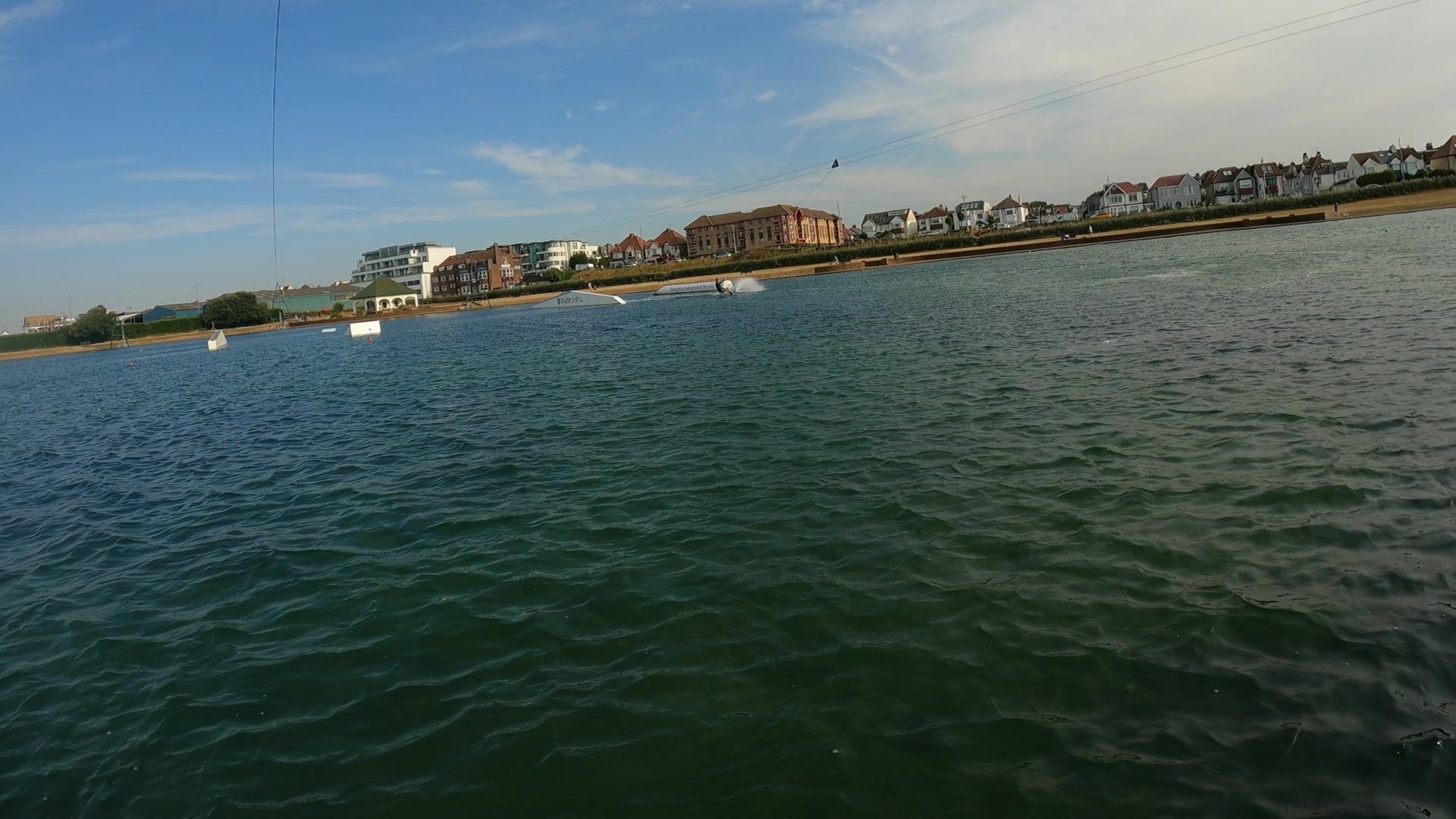 Another rider on the cable, seafront behind
